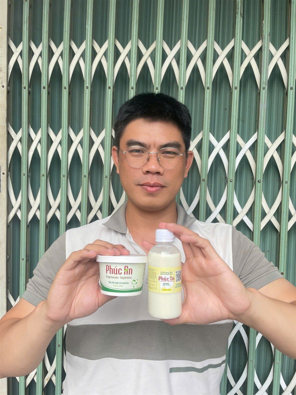 Đức - người sáng lập Tàu Hũ Tươi Phúc An, cầm hũ tàu hũ tươi Matcha